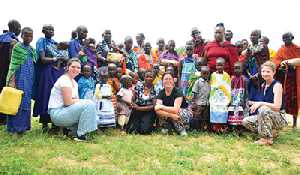 Three local women volunteer in Tanzania, and deliver Little Dresses made by Wawota group